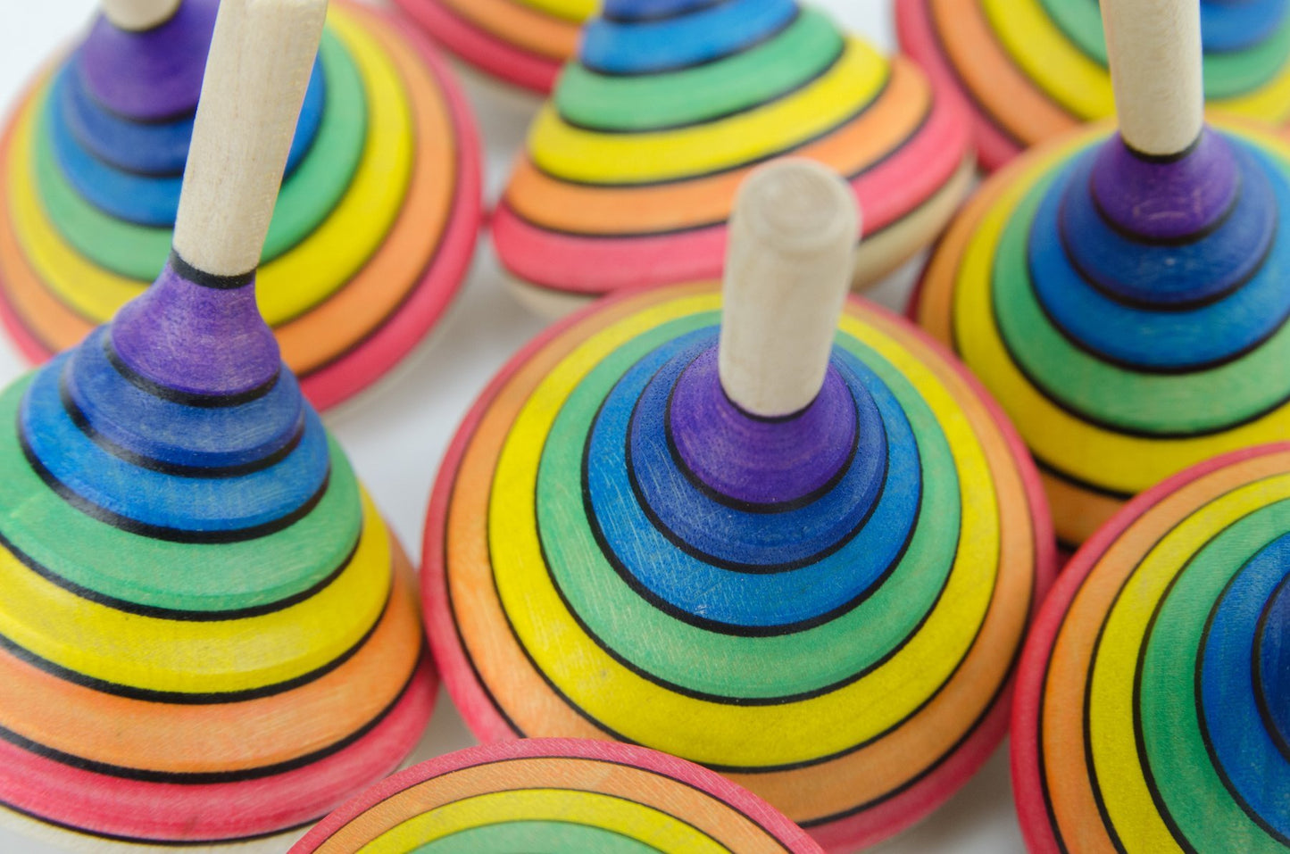 Mader _ rainbow spinning top multiple close up _ Little Toy Tribe